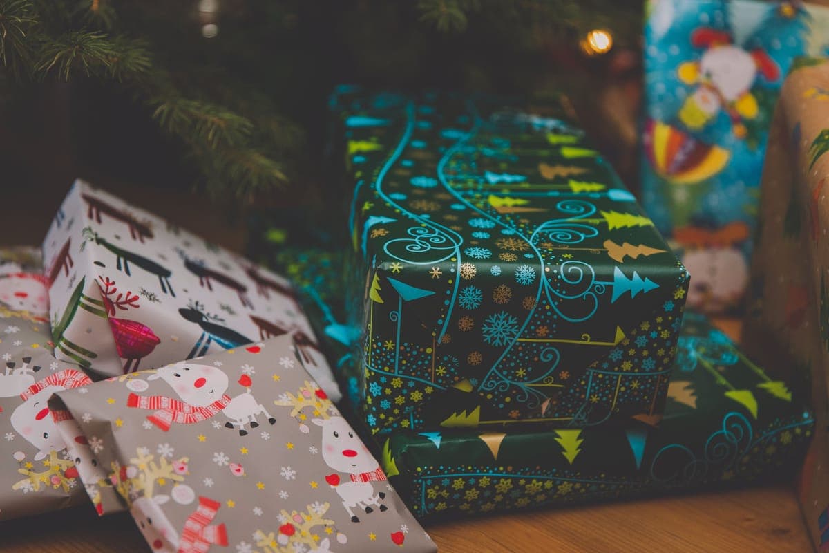 Wrapped Christmas presents beneath a decorated tree