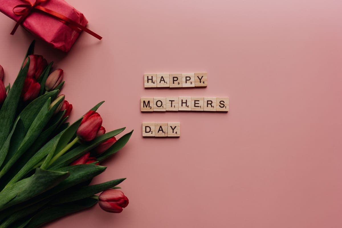 Tulips arranged beside a wrapped gift