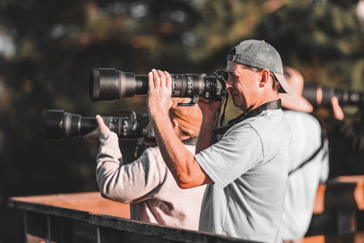 Photographers using telephoto lenses outdoors