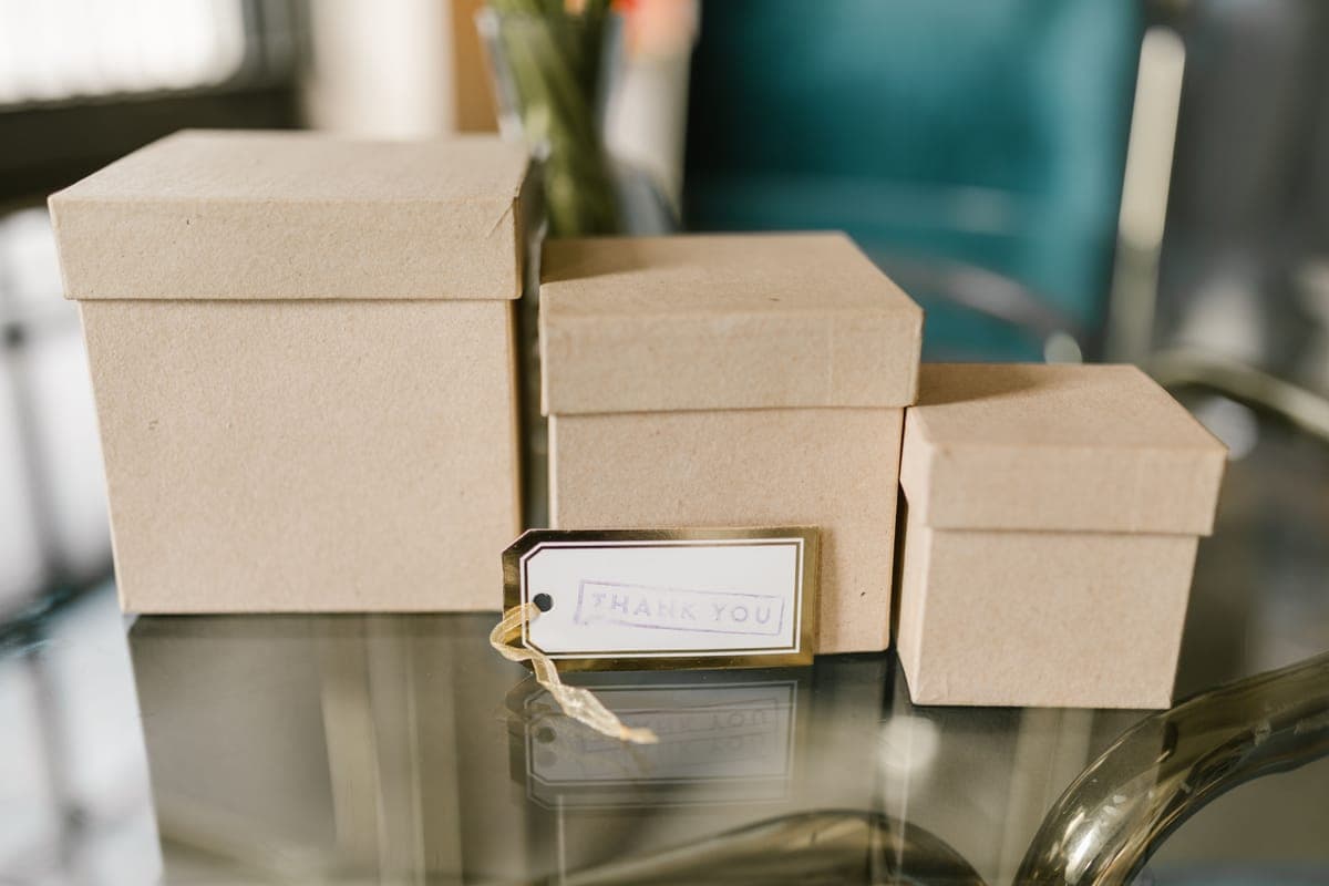A small wrapped gift box with a paper tag on a table