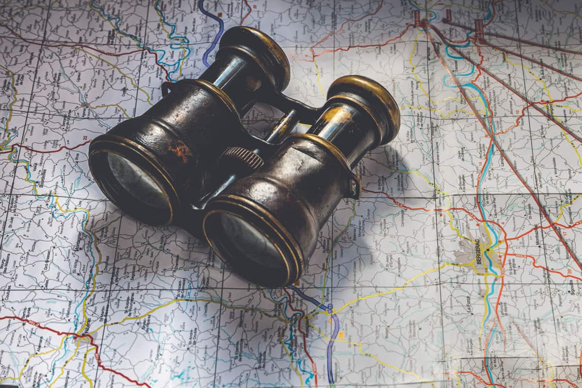 Binoculars resting on an open paper map